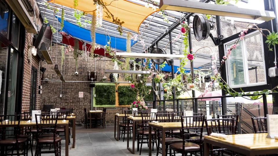Patio tables under sail canopies